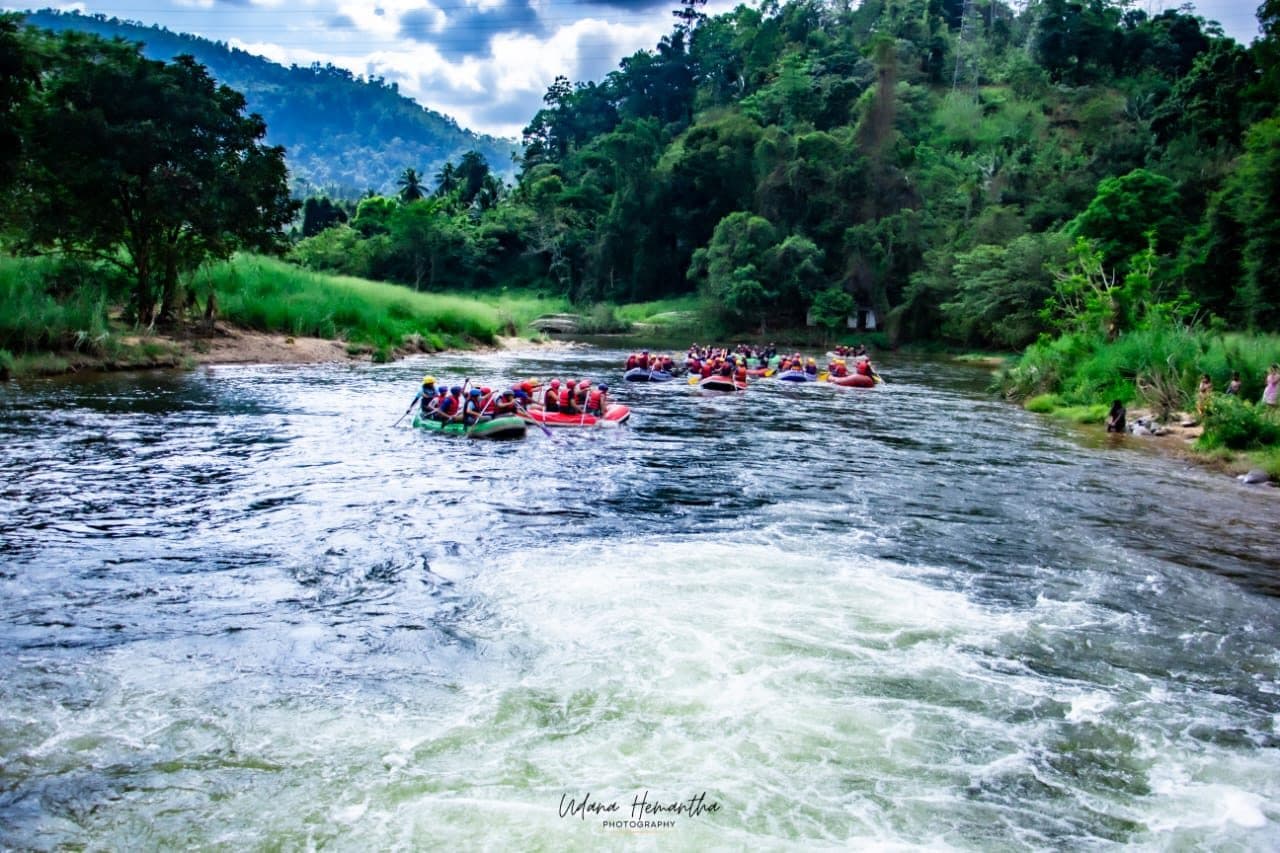 Rafters punching through grade 2-3 rapids on the Kelani River with Xclusive Adventures guides in Kitulgala, Sri Lanka